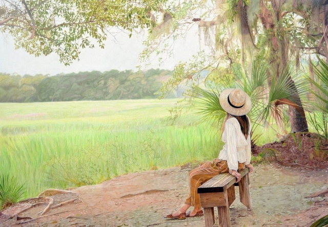 A young girl sitting near a forest enjoying the solitude and peace of nature.